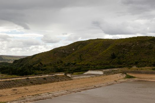 Close up view of the low Water levels at the Loerie Dam on a cloudy day.