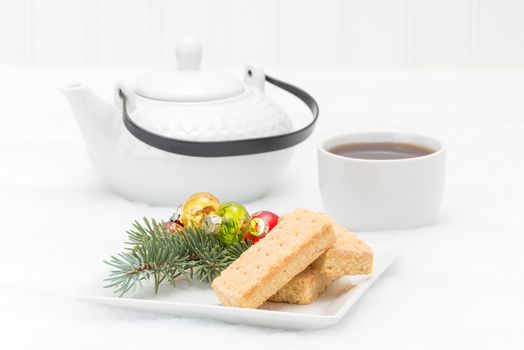 Delicious homemade shortbread cookies on a plate with Christmas decorations.