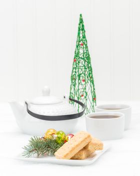Delicious homemade shortbread cookies with hot tea and Christmas decor.