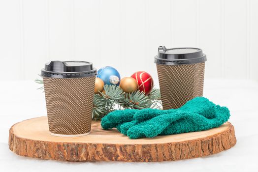 Hot coffee in paper cups on a festive background.