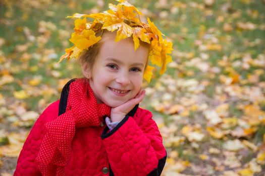 Cute girl in autumn wreath close-up