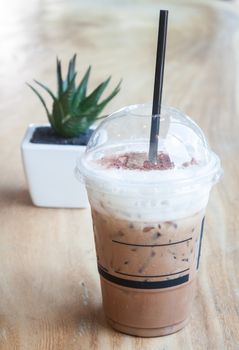 Iced coffee with green plant background, stock photo