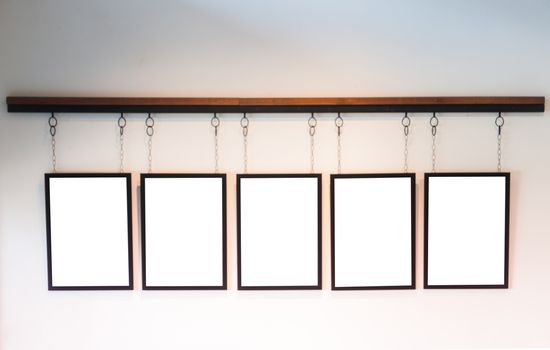 Blank boards hanging on white wall background, stock photo