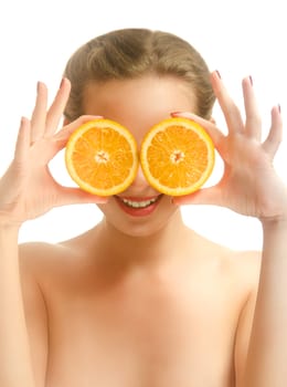 Young funny woman covering her eyes with orange slices. White background.
