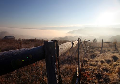 sunrise with fog over field at autumn