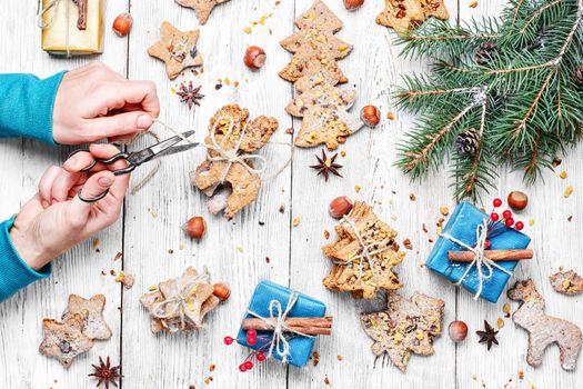 Female hands creating gifts for Christmas Christmas homemade cookies