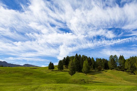 panoramic view of the Seiser Alm in a sunny day with blue sky and clouds