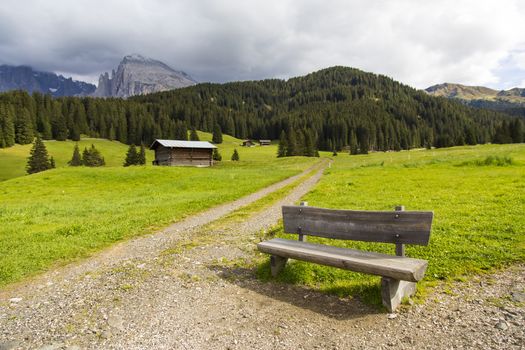 View of a bench near a hiking trail in Seiser Alm