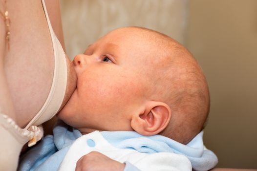 Mother breastfeeds the baby close up shot