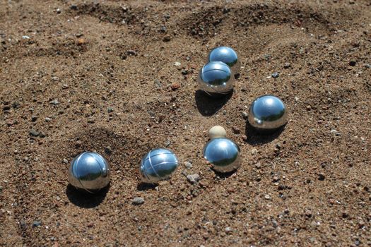 Petanque balls on sandy close to  