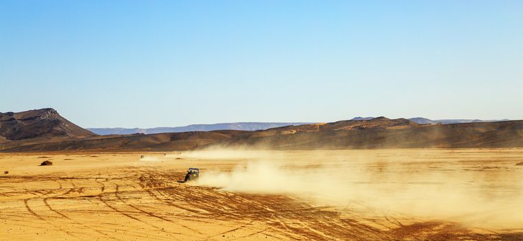 panoramic view on convoys of off road cars with in Morocco desert near Merzouga