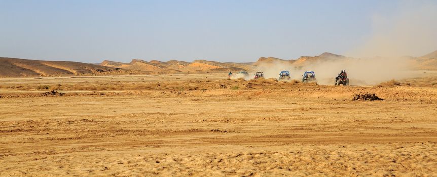 panoramic view on convoys of off road cars with in Morocco desert near Merzouga