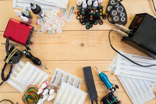 Tattoo machines and equipment on the wooden background