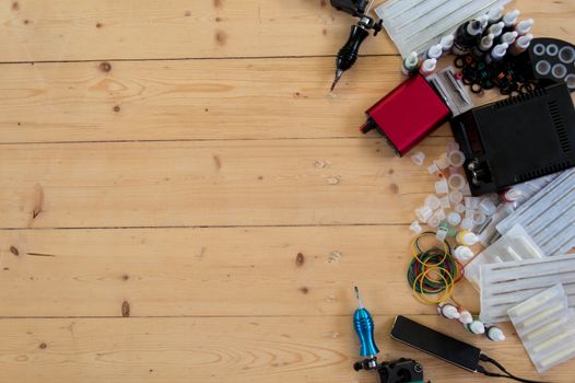 Tattoo machines and equipment on the wooden background