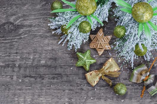 Various Christmas decorations on old gray wooden background. A place for a label.