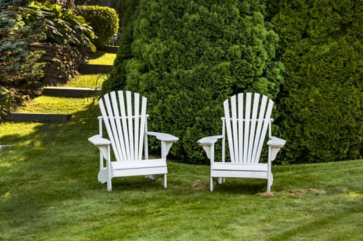 two adirondack chairs on the grass in Maine, USA