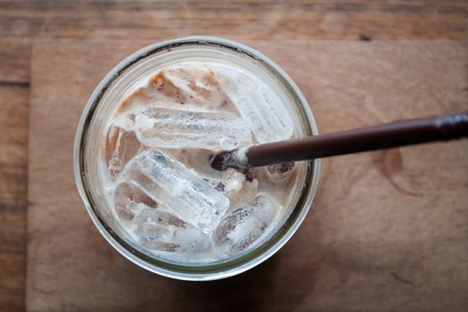 Top view of iced coffee on wooden table, stock photo