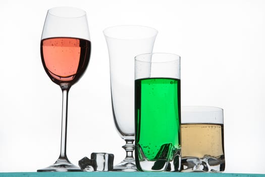Glasses and beverages on a studio background