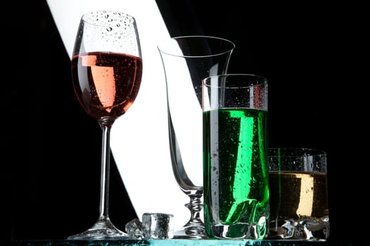 Glasses and beverages on a studio background
