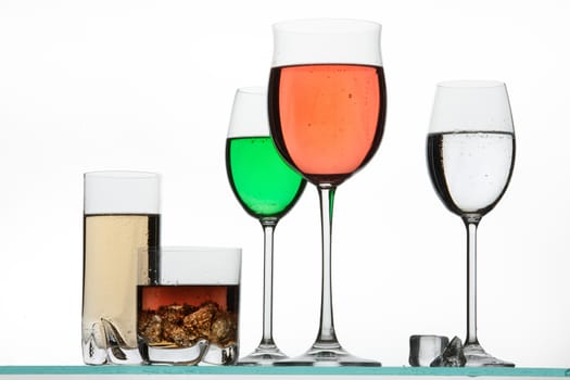 Glasses and beverages on a studio background