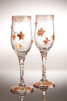 Wineglasses with painting on a glass studio background