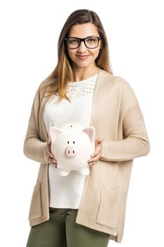 Beautiful and happy woman holding a piggy bank, isolated over white background