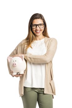 Beautiful and happy woman holding a piggy bank, isolated over white background