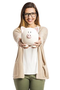 Beautiful and happy woman holding a piggy bank, isolated over white background