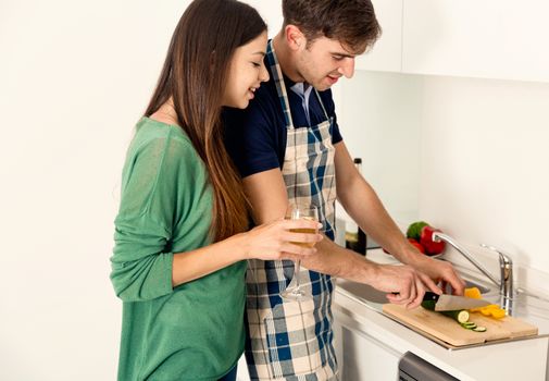 Young couple on the kitchen cooking