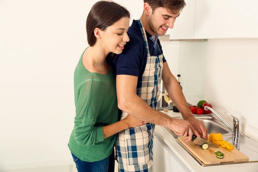 Young couple on the kitchen cooking