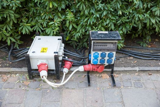 Electric switchboard is in the bushes. And thick cables connected to it