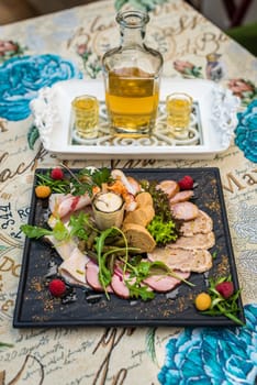 Meat dish on the table with honey vodka