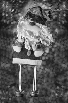 Santa Claus, holiday background bokeh. Christmas decoration hanging, black and white image