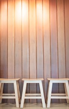 Three wooden chairs on wall background, stock photo