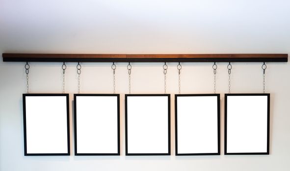 Blank boards hanging on white wall background, stock photo