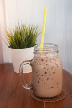 Iced coffee with green plant background, stock photo