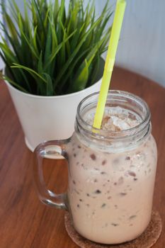 Iced coffee with green plant background, stock photo