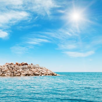 sea, rocky shore and blue sky