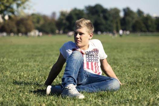 Portrait of a boy fourteen years of age in the grass