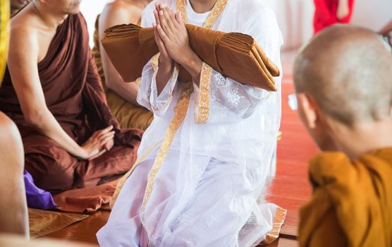 Close-up to Newly ordained Buddhist monk pray with priest procession. Newly ordained Buddhist monks have a ritual in the temple procession.