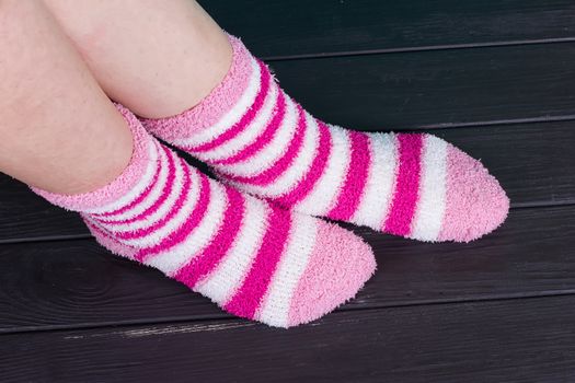 beautiful legs woman with socks standing on tiptoe on the wooden floor