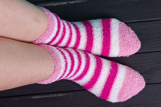 beautiful legs woman with socks standing on tiptoe on the wooden floor