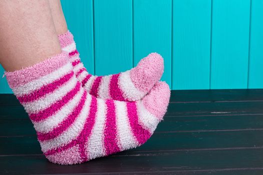 beautiful legs woman with socks standing on tiptoe on the wooden floor