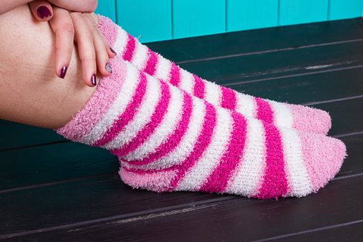 beautiful legs woman with socks standing on tiptoe on the wooden floor