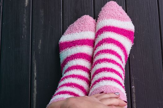 beautiful legs woman with socks standing on tiptoe on the wooden floor