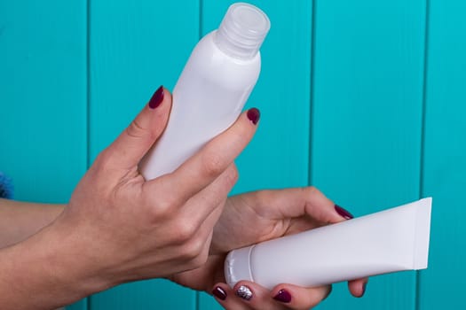 Close view of girl's hand with a 2 white tube
