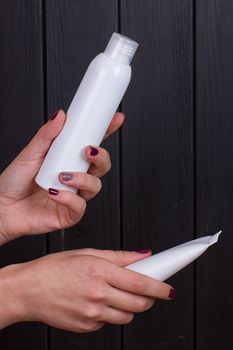 Close view of girl's hand with a 2 white tube