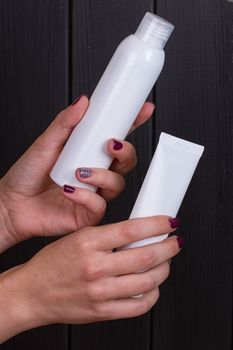 Close view of girl's hand with a 2 white tube