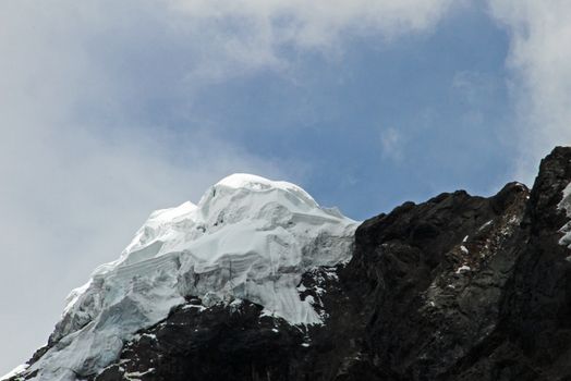 Nice mountain peak with clouds in the peruvian Cordillera Blanca