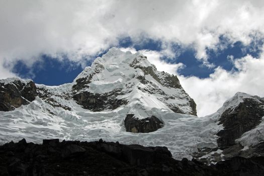 Nice mountain peak with clouds in the peruvian Cordillera Blanca